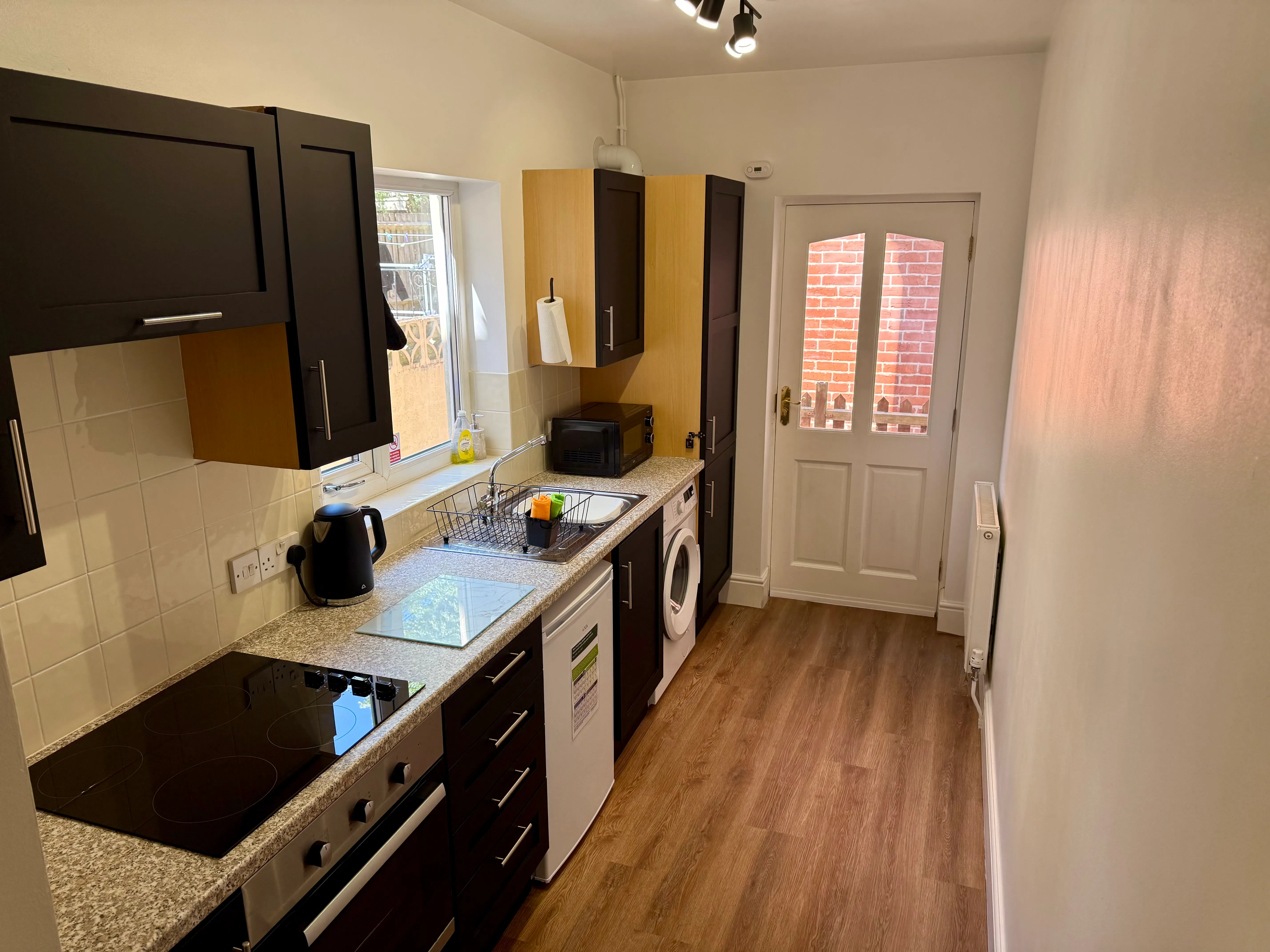 The galley kitchen with oven, hob and washing machine